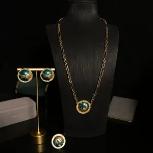 Elegant gold-tone metal green enamel earth globe pendant necklace earrings and ring set.