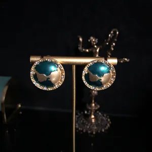 Exquisite enamel planet earrings with sparkling rhinestones, elegant gold-toned jewelry for women.