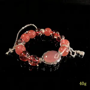 Detailed view of luxury crystal beaded bracelet with sparkling pink stones and silver charms.