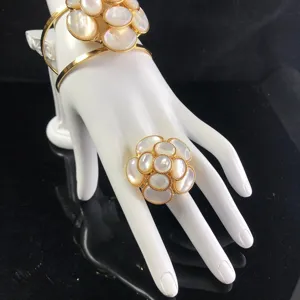 Exquisite gold mother-of-pearl camellia flower cuff bracelet and ring product detail.
