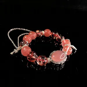 Crystal beaded bracelet detail shot, pink quartz stones and silver metal accessories design.