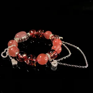 Close-up detail of crystal bead bracelet with silver chain charms for women fashion.