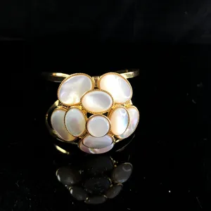 Elegant gold-tone mother-of-pearl camellia flower cuff bracelet for women, luxury chic style.