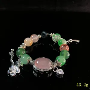 Crystal gemstone beaded bracelet with silver charms, detailed view of exquisite craft.