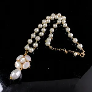 Mother-of-pearl camellia pearl necklace featuring elegant French style pendant and golden chain.