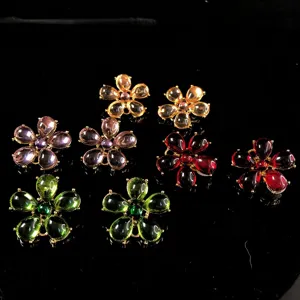Close-up detail of vintage style colorful resin flower jewelry studs and accessories.