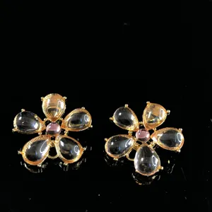 Detail view of vintage gold flower crystal earrings, exquisite transparent drop stones.