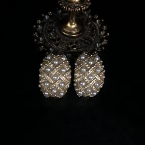 Vintage gold tone pearl rhinestone earrings detail shot, elegant court style chic jewelry accessory.