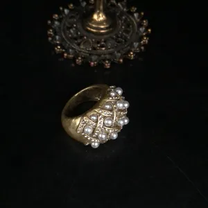 Vintage retro gold-tone pearl rhinestone ring detail close-up view fashion accessory.