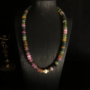 Natural multi-color tourmaline flat bead necklace featuring a central pearl and chic metallic accents.