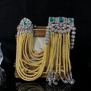 Vintage emerald rhinestone pearl tassel brooch detail shot, ornate multi strand pearl design.