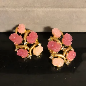 Close-up detail of pink 3d rose flower earrings with gold branch design and rhinestones.