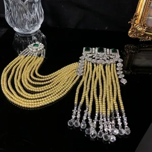Vintage retro style multi-strand pearl crystal tassel brooch with green gemstone details.