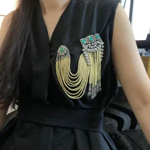 Vintage heavy design emerald pearl tassel brooch, exquisite crystal rhinestone jewelry detail.