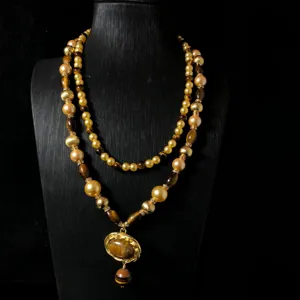 Close-up detail of the retro double-layer beaded necklace featuring tiger eye stone pendants.