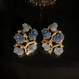 Exquisite blue rose floral drop earrings detail shot, elegant gold-plated statement jewelry.