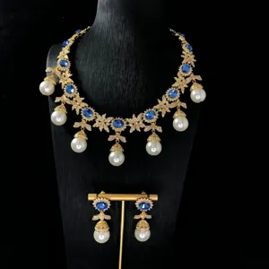 Detail shot of vintage blue rhinestone pearl tassel necklace and matching earrings set.