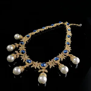 Vintage style sapphire pearl necklace detail, exquisite gold-tone floral crystal design.