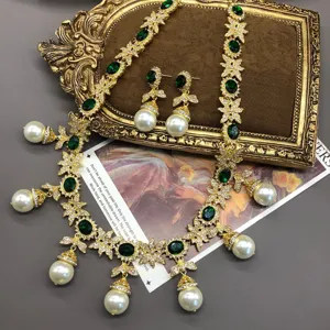 Detailed close-up shot of vintage gold-tone green crystal pearl tassel necklace jewelry.