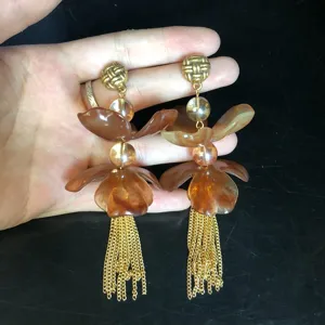 Elegant long floral tassel earrings featuring amber resin petals and gold-plated chains for women.