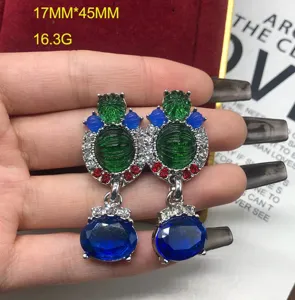 Exquisite statement drop earrings with green and blue stones, ornate rhinestone details.