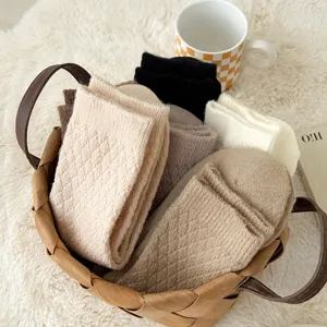 Detailed view of cozy winter knit socks with classic diamond pattern in basket.