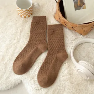 Brown vintage argyle knit mid-calf socks detail shot showing cozy winter texture.