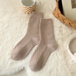 Close-up of cozy knitted socks with retro diamond pattern, textured warm winter socks detail.