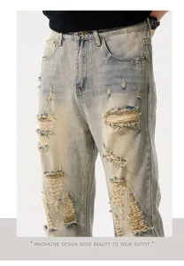 Men's distressed loose straight denim jeans, vintage blue wash with ripped details and retro style.