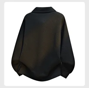 Textured detail of men loose black sweatshirt showing fabric pattern and casual fit back view
