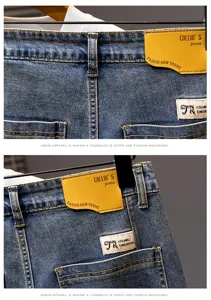 Dettaglio jeans in denim, lavaggio blu vintage, toppa in pelle premium e etichetta tessuta.