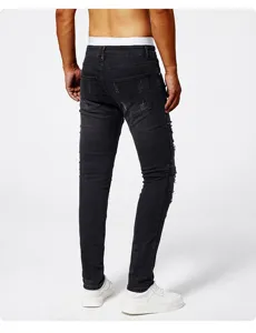Back detail of men's black slim fit distressed skinny jeans with stretch denim and ripped knees.