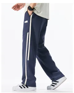 Detail view of men's casual loose straight sweatpants with contrast side stripes for autumn.