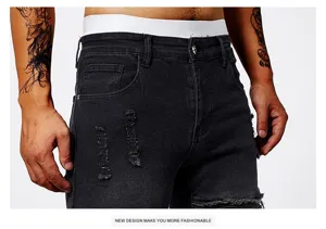 Men's black ripped slim fit denim jeans detail view showing distressed fabric and casual style.