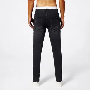 Men's black distressed skinny stretch denim jeans shown from back view in a studio setup.