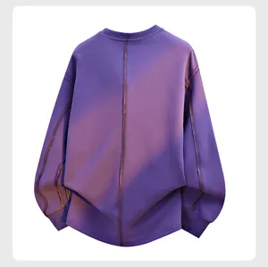 Close-up detail of the purple sweatshirt back showing vertical decorative seam lines texture.