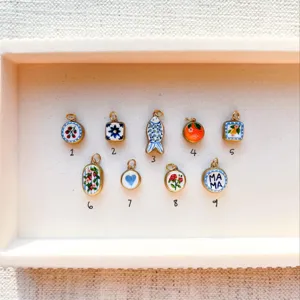 Detailed view of various colorful DIY enamel pendant charms in 18k gold plating