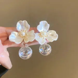 Elegant acrylic flower earrings with pearl center and clear glass bubble pendant for women.