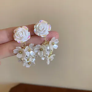 Elegant white acrylic flower tassel earrings, chic floral drop jewelry for daily wear.