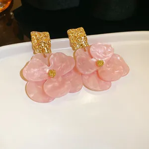 Elegant pink acrylic flower earrings detail shot, chic and stylish fashion jewelry accessory for women.