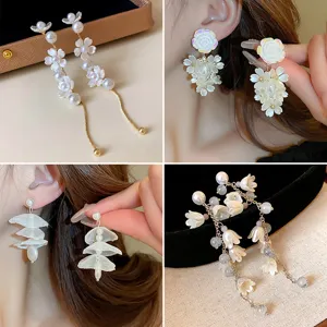 White flower pearl tassel earrings for women, elegant forest style floral ear studs and drops.
