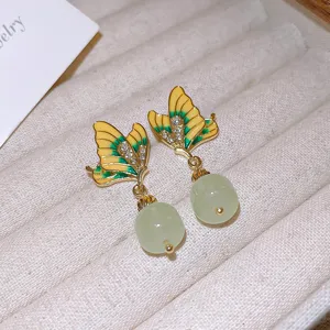 Summer sweet butterfly earrings with green enamel rhinestones and hanging beads detail shot.