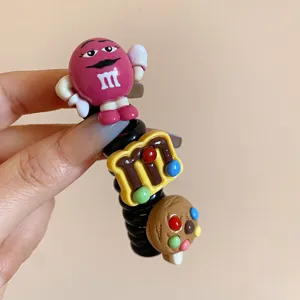 Closeup of cute cartoon character telephone wire hair tie, sweet hair accessory detail.
