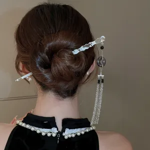Détail de bâton de cheveux à pampilles style chinois, épingle élégante, accessoire traditionnel.