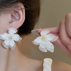 Detailed close-up view of the elegant white layered flower earrings showcasing exquisite floral design.