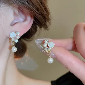 Exquisite white flower pearl earrings with sparkling rhinestones and elegant tassel design.
