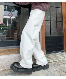 American style heavy white loose cargo pants with multiple pockets and wide leg detail.