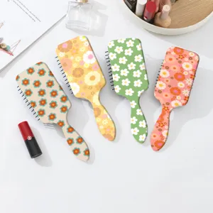 Detailed view of cute floral air cushion hair brushes in four stylish retro pastel color designs.