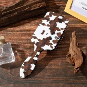 Cow print paddle hair brush with air cushion massage design for daily scalp care and anti static styling.