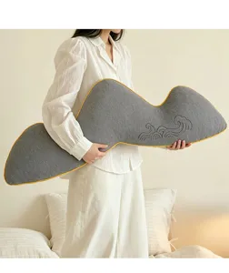 Grey irregular shaped long bed pillow detail showcasing nice yellow piping and wave embroidery.